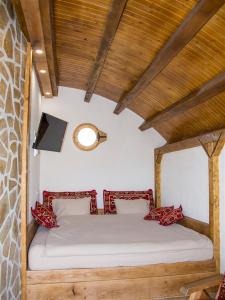 A bed or beds in a room at Mountain bungalows and a Hobbit House - Jazavčije Rupe