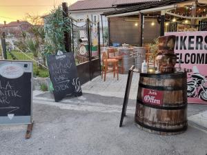a store with a barrel and a sign in front of it at Vila Antik in Ilirska Bistrica