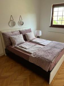 a bed in a bedroom with two lights above it at Apartments Han in Sarajevo