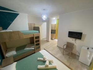 a small room with a bunk bed and a desk at Villa Luan Ksamil in Ksamil