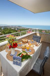 - une table avec des assiettes de nourriture sur un balcon donnant sur l'océan dans l'établissement Al Jannah Residence, à Trabzon