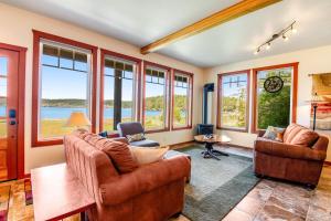 a living room with a lot of windows at Mackaye Road Manor in Islandale