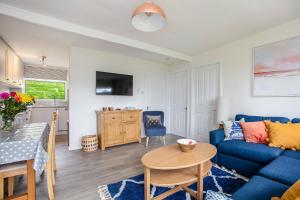 a living room with a blue couch and a table at 328 Norton Park, Dartmouth in Dartmouth