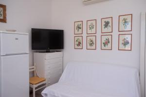 a bedroom with a bed and a tv on a wall at N236 - Numana, bilocale vista mare nel cuore del paese in Numana