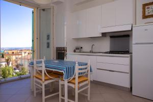a kitchen with a table with a blue and white table cloth at N236 - Numana, bilocale vista mare nel cuore del paese in Numana