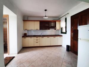 a kitchen with white cabinets and a sink at Spacious Holiday House with Shared Pool in Hanioti