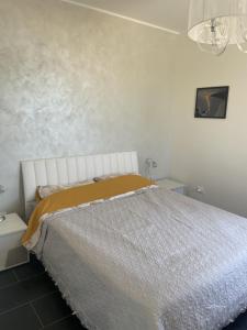 a bedroom with a bed with a gold blanket at Capovaticano - Unique SEA VIEW - Villa Renaissance in Santa Maria +25 photos