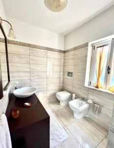 a bathroom with a sink and a toilet in it at Capovaticano - Unique SEA VIEW - Villa Renaissance in Santa Maria