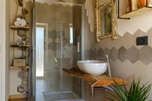 a bathroom with a sink and a glass shower at SANTINO'S HOUSE in Peveragno +133 photos
