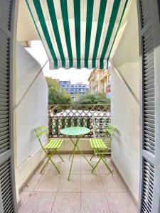 a patio with a table and chairs on a balcony at Chez Chebil in rue Halevy - near the sea in Nice