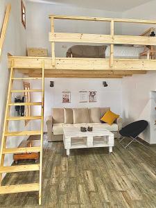 a living room with a loft bed and a couch at Casa Rural El Altillo in Letur