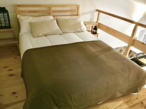 a large bed in a room with wooden floors at Casa Rural El Altillo in Letur +4 photos