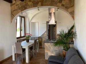 a living room with a table and a stone wall at Casa Balilla in La Maddalena