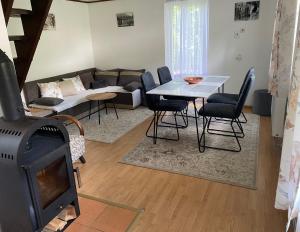 a living room with a couch and a table with a fireplace at Chalupa Hanuliak in Terchová