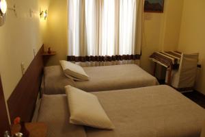 Un pat sau paturi într-o cameră la Picol Hostal