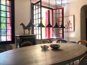 a dining room table with a bowl of fruit on it at B&B Villa Roumanille in Aix-en-Provence