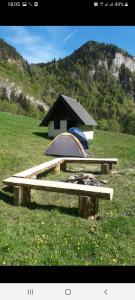 a picnic table in a field with a tent at Apartments Avramovic in Žabljak