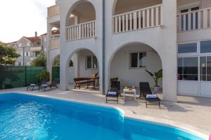 a patio with a swimming pool and a house at Villa Anja Lux, Split in Split