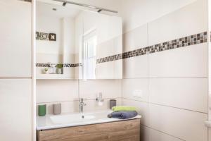 a bathroom with a sink and a mirror at Ferienhaus Schlagerbauer Biohof in Salzburg +24 photos