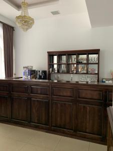 a kitchen with wooden cabinets and a chandelier at Laura Holiday in Brăila