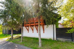 a tree house with a deck on a wall at Apartament Via Regia in Krościenko