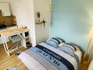 a small bedroom with a bed and a sink at Le p'tit Mersois in Mers-les-Bains