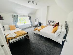 a bedroom with two beds and a window at Southview in Ganton