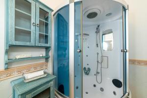 a bathroom with a shower and a blue cabinet at RUSTICO PETRA - Regarda Travel in Bardolino +32 photos
