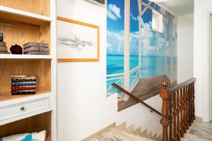 a stairway with a painting of the ocean at RUSTICO PETRA - Regarda Travel in Bardolino