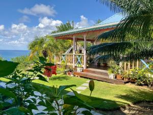 a house with a deck and the ocean in the background at Villa Caribbean Dream in Vieux Fort