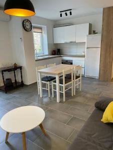 a kitchen and living room with a table and chairs at Apartman Mihaela in Rab