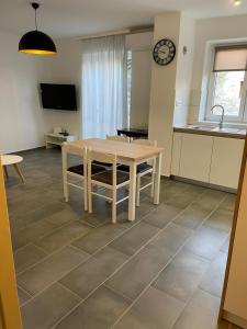 a kitchen and dining room with a table and a sink at Apartman Mihaela in Rab