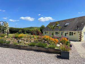 a garden in front of a house at Westerley Country B & B with exclusive Guest lounge in Buckfastleigh