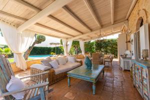 a living room with a couch and a table at Villa Letto D'Alloro - Royal Dream in Conversano