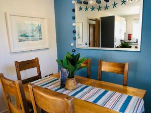 a dining room with a table and a mirror at Starfish Cottage in Charlestown