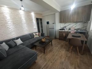 a living room with a couch and a kitchen at MELENIOS HOUSES in Samothraki