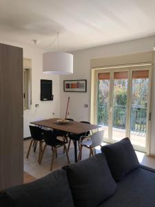 a living room with a table and chairs and a couch at playa home in Catania