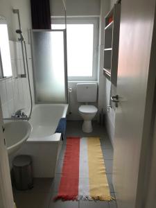 a bathroom with a white toilet and a sink at Haus Potosi, Travemünde in Lübeck +23 photos