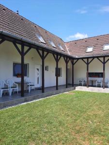 a patio with chairs and a table and a roof at Apartment in Balatonboglar 38010 in Balatonboglár