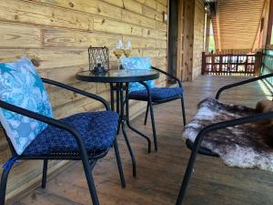 a table and chairs on a porch with a table and chairs at Chata u Samka in Rimavská Sobota