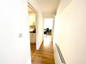a hallway of an apartment with a kitchen and a living room at Apartment in Oxfordshire in Sunningwell
