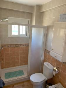 a bathroom with a toilet and a shower at Las Delicias de Estepona in Estepona +24 photos