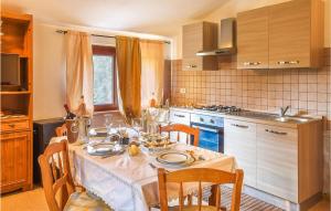 a kitchen with a table with a white table cloth at Beautiful Apartment In Bacu Abis With Kitchen in Bacu Abis