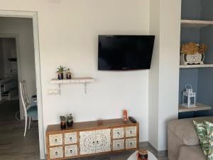 a living room with a flat screen tv on a wall at Apartamento en sanxenxo Aldodi in Sanxenxo