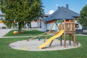 um parque infantil com escorrega num parque em Hedon Brewing Credo apartment - 200 meter to the Beach em Balatonvilágos