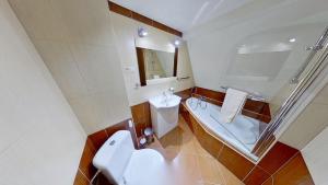 a bathroom with a tub and a toilet and a sink at Chalupa Ždiar in Ždiar +16 photos