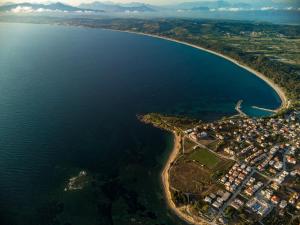 an aerial view of the shoreline of a lake at Adonis Hotel in Mitikas