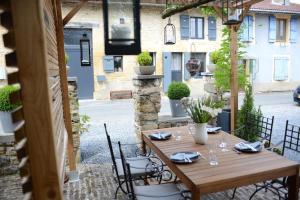 a wooden table and chairs on a patio at Le Nid de Louppy in Louppy-sur-Loison