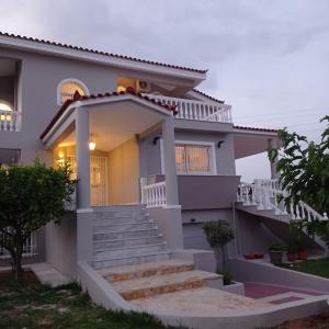 a house with stairs in front of it at Villa Costa in Periyiálion