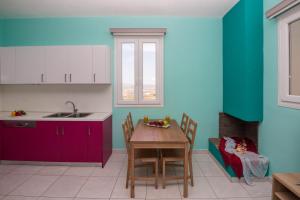 Stone house Tripiti في تريبيتي: مطبخ مع طاولة وكراسي ونافذة
